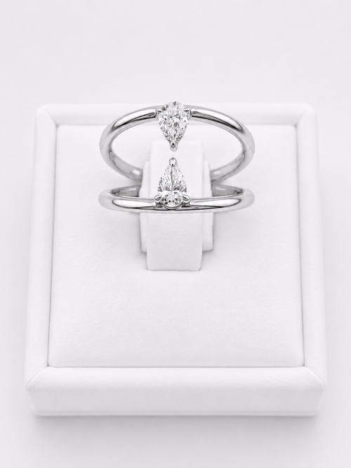 Ring With Two Lines And Two Pear Cut Diamonds